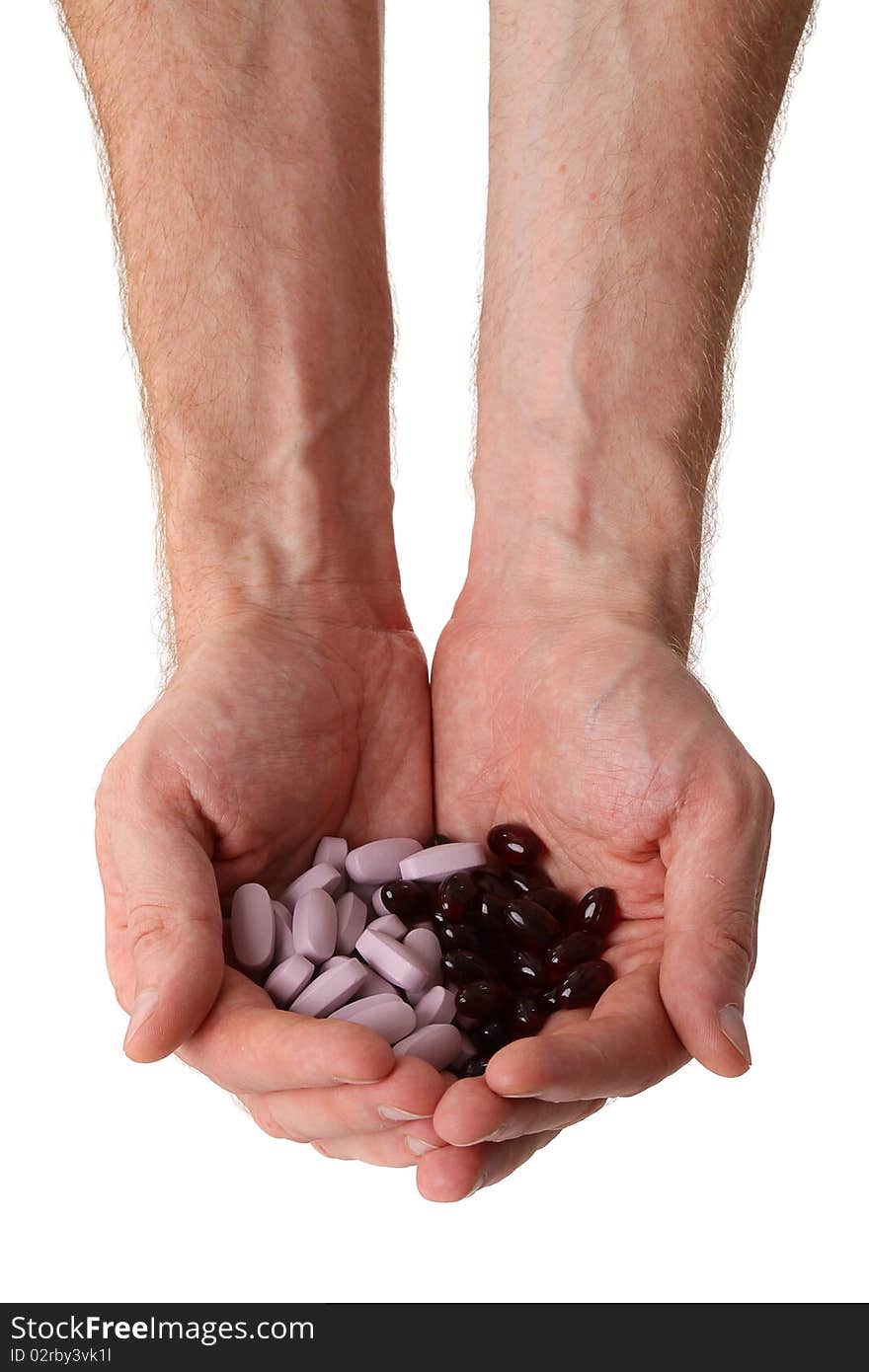 Pills in two male hands isolated on white background