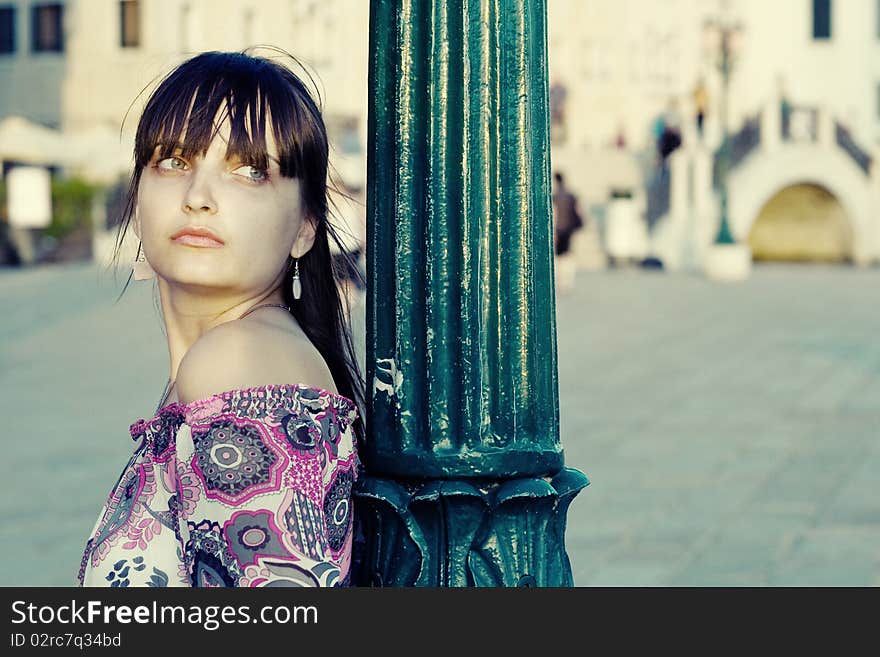 Portrait of beautiful young woman in Venice. She's waiting for someone. Space for text available. Portrait of beautiful young woman in Venice. She's waiting for someone. Space for text available.