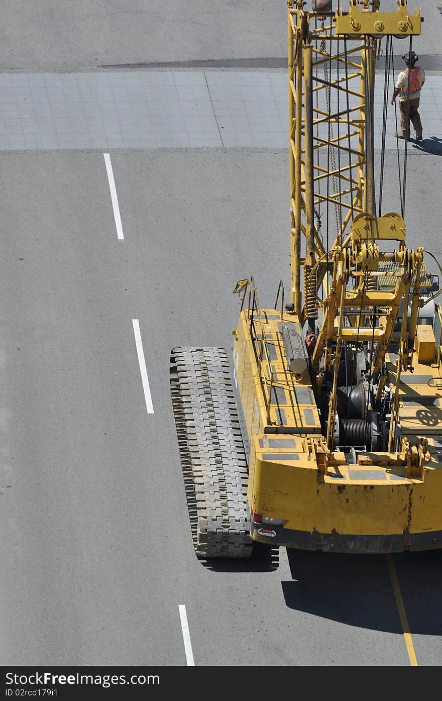 Crane truck with worker on road