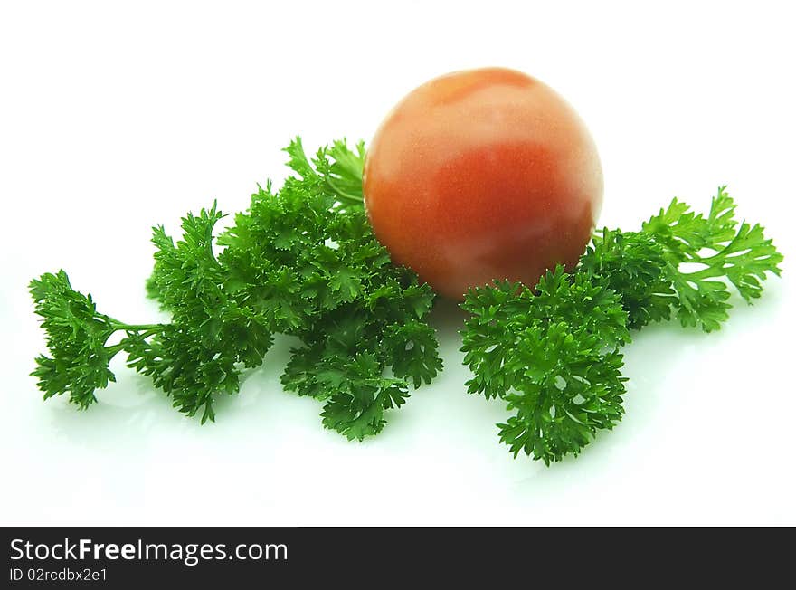 Tomatoes with greens on white background