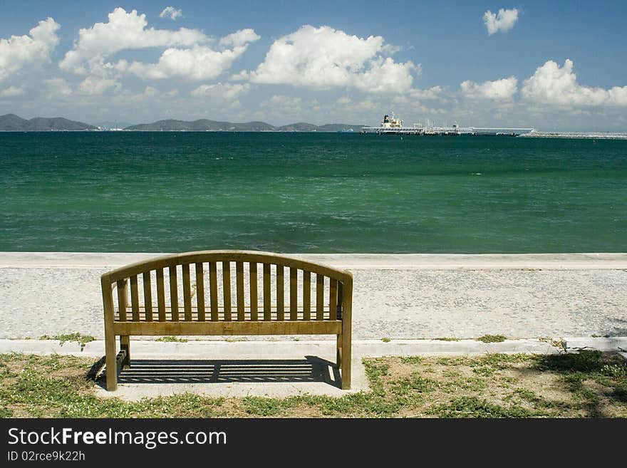 Lonely chair over the green sea.