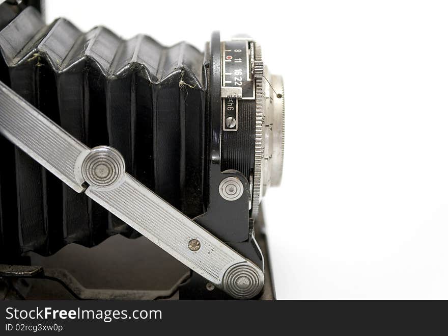 Old photographic camera isolated on white background