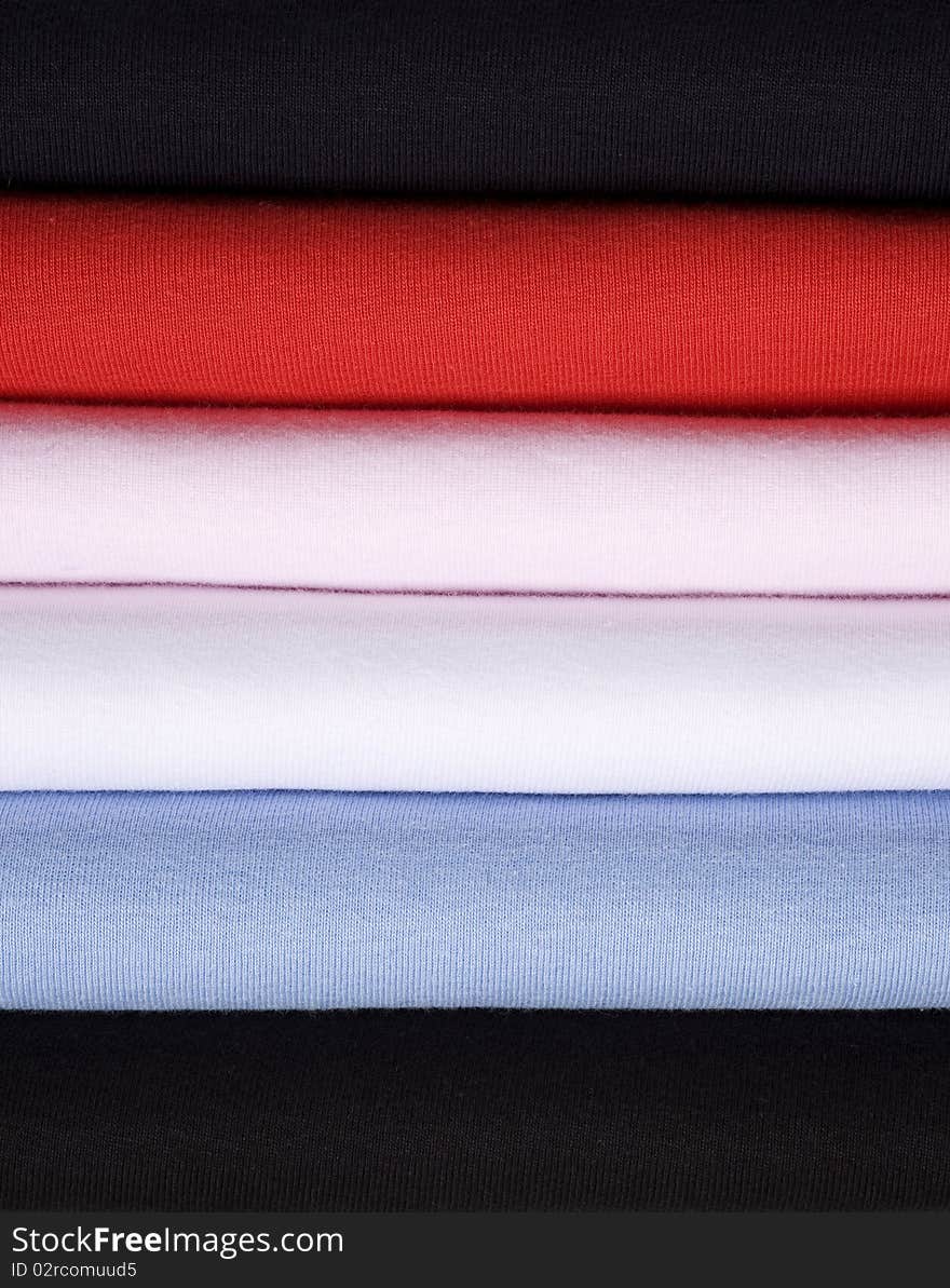 A stack of sweaters shot in a close up.