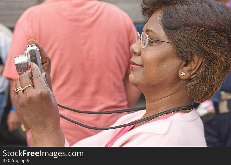 An image of a woman taking pictures of traction Engines at Pickering using a point and shoot camera. An image of a woman taking pictures of traction Engines at Pickering using a point and shoot camera.