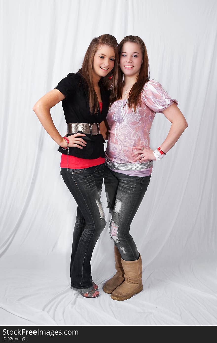 Portrait of two smiling teens on white background. Portrait of two smiling teens on white background.