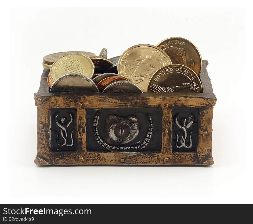 Miniature treasure chest full of coins on white background. Miniature treasure chest full of coins on white background