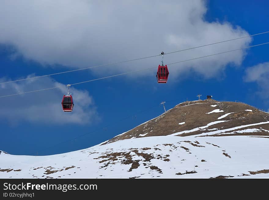 Red Cable Car On Snow Mountain