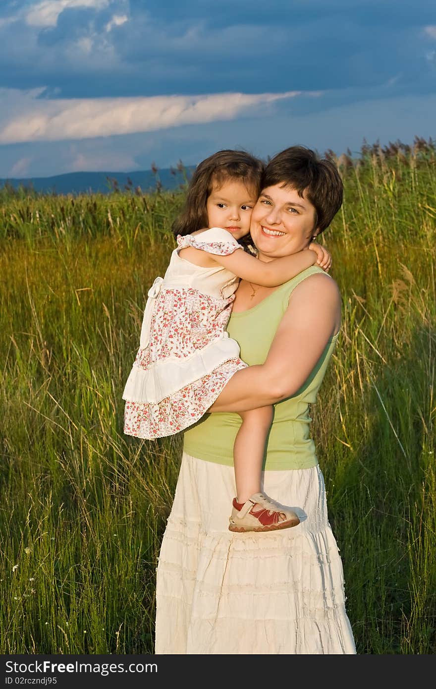 Little Girl And Her Mother Staying Outside