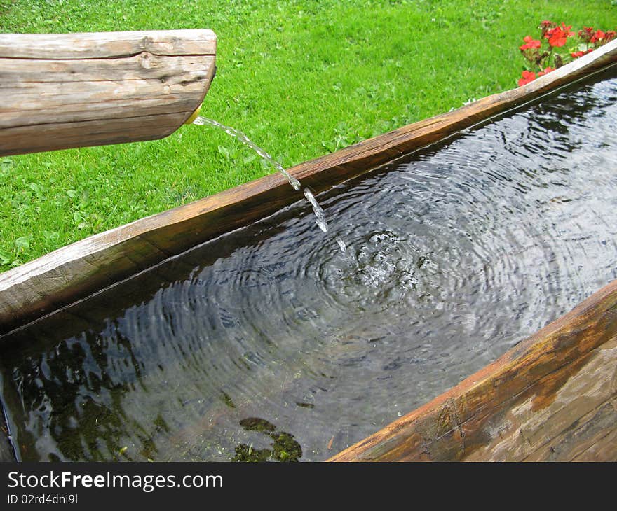 Detail of wooden fountain in mountain village. Detail of wooden fountain in mountain village