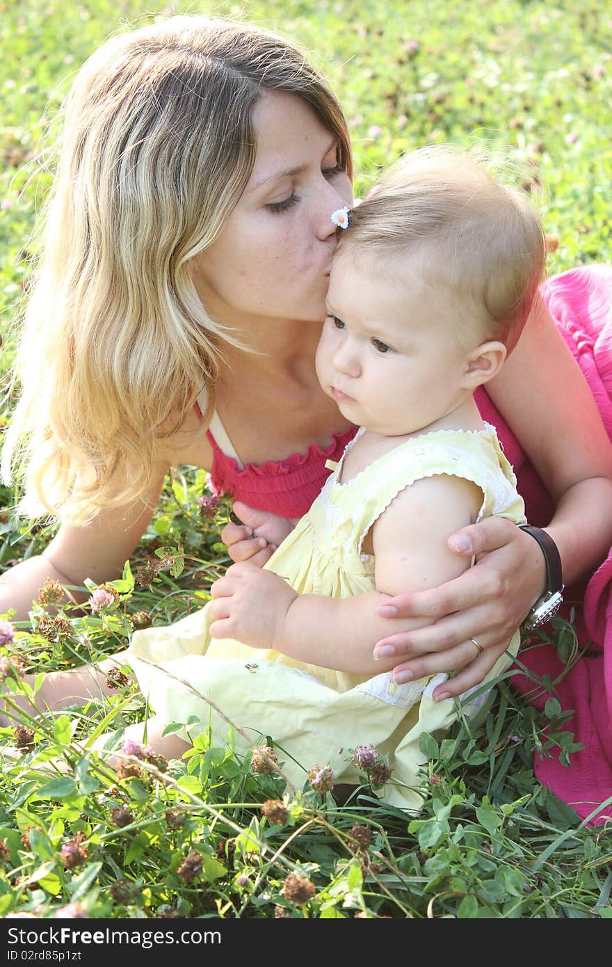 The mum kisses by the daughter. The mum kisses by the daughter