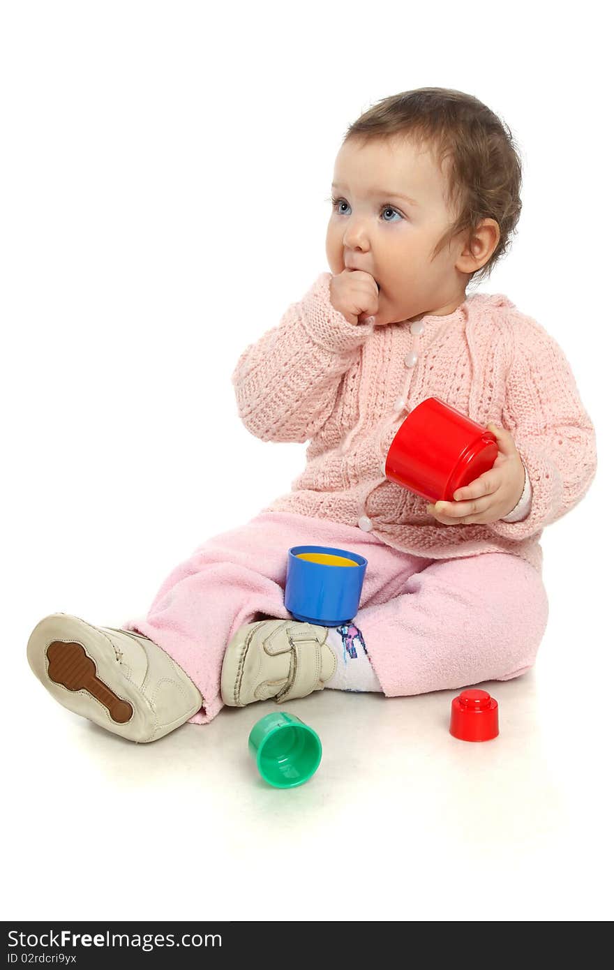 Surprised baby playing with toys