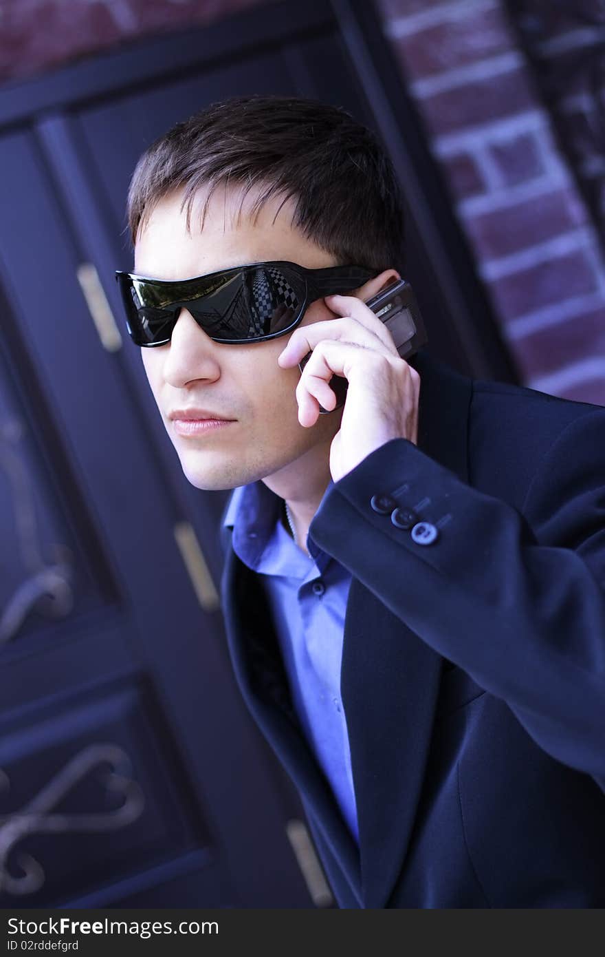 Man in black glasses talking on the phone