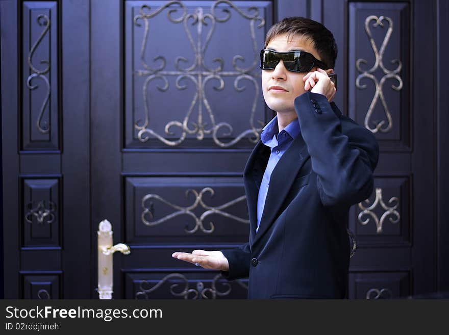 Man in black glasses talking on the phone