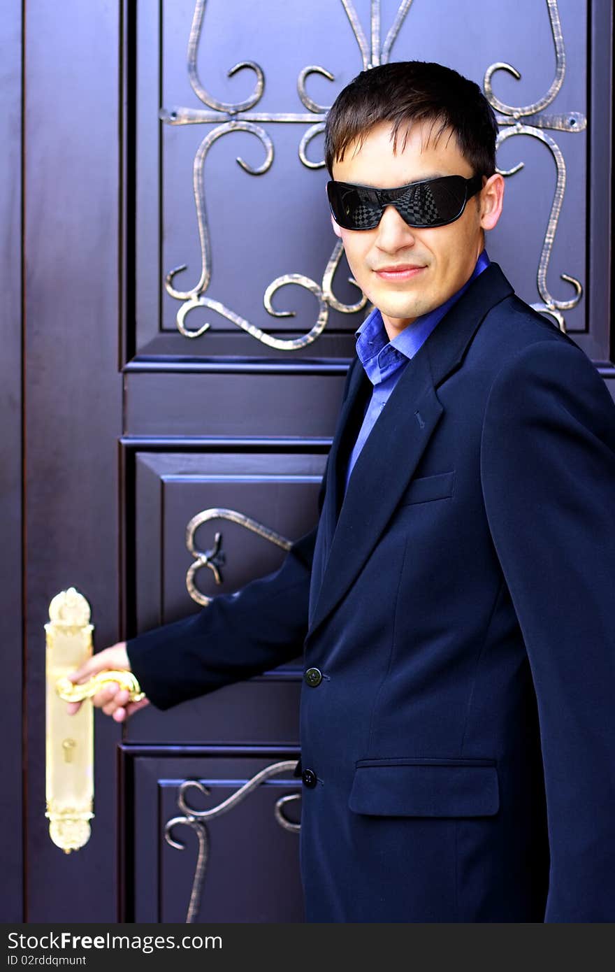 Man in black glasses next to the door