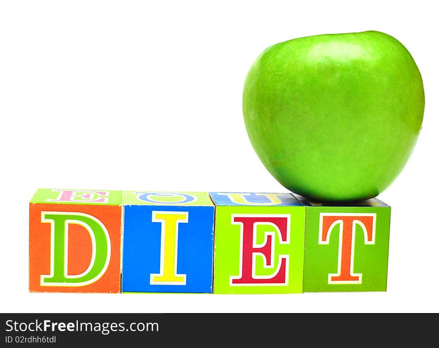 Green apple and cubes with letters in front of a white background - diet. Green apple and cubes with letters in front of a white background - diet