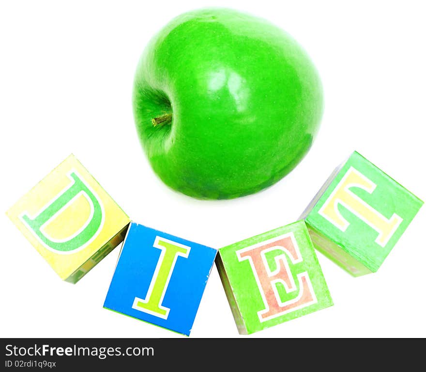 Green apple and cubes with letters in front of a white background - diet. Green apple and cubes with letters in front of a white background - diet