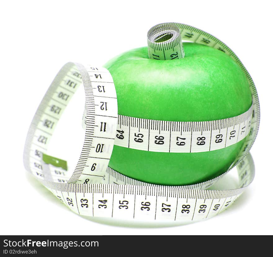 Tape measure wrapped around green apple isolate on white