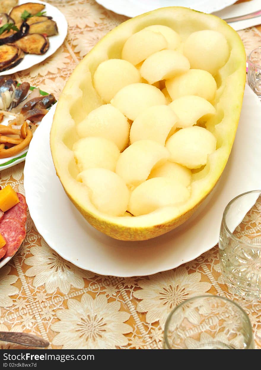 The ripe cut melon on a table. The ripe cut melon on a table