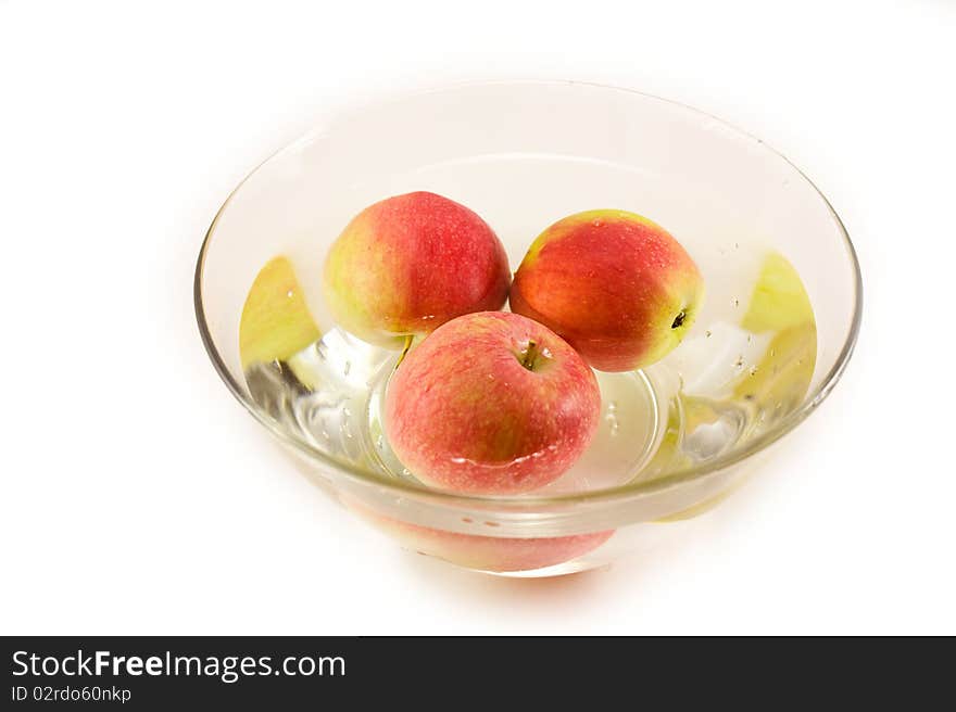 Ripe apples floating in a bowl with water. Ripe apples floating in a bowl with water