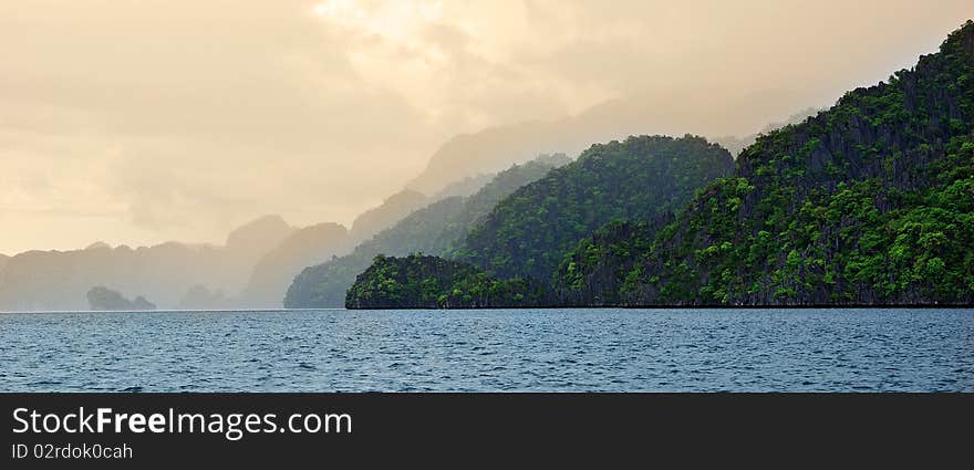 A mist covers the black island in Coron right after a short rainshower. A mist covers the black island in Coron right after a short rainshower.