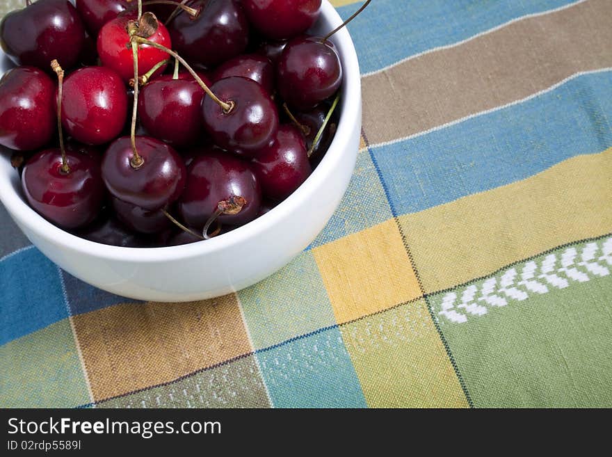 A white bowl of cherries