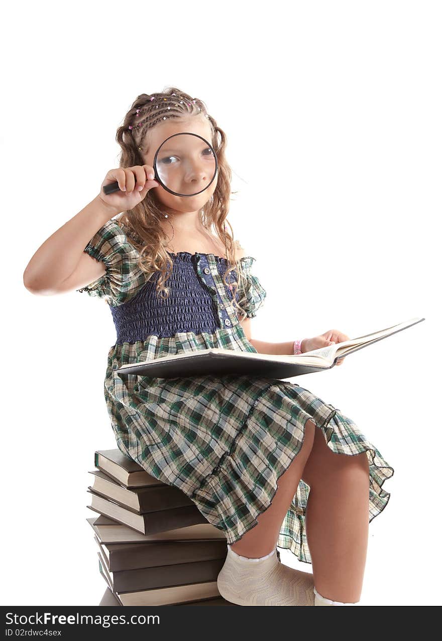 Little girl looking through magnifying glass