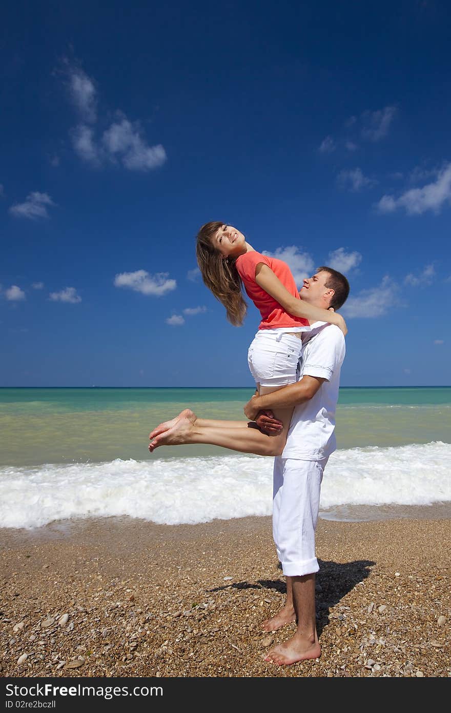 Young attractive couple fooling around on the beach. Young attractive couple fooling around on the beach