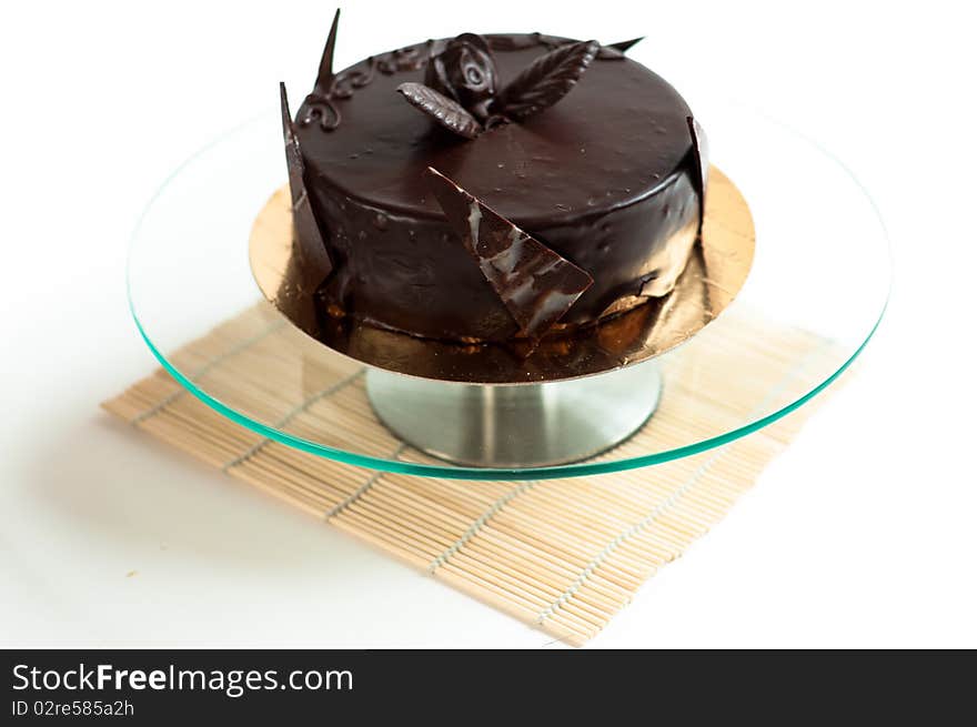 Chocolated cake on isolated background with rose and petals. Chocolated cake on isolated background with rose and petals