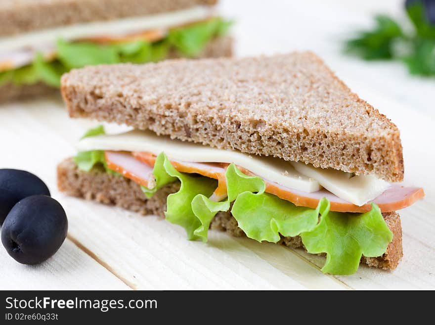 Close up of sandwich on wooden table top