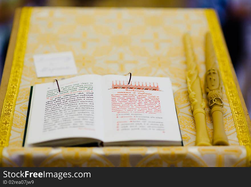 Orthodox wedding. church, the open gospel, wedding candles and priest's glasses. Orthodox wedding. church, the open gospel, wedding candles and priest's glasses