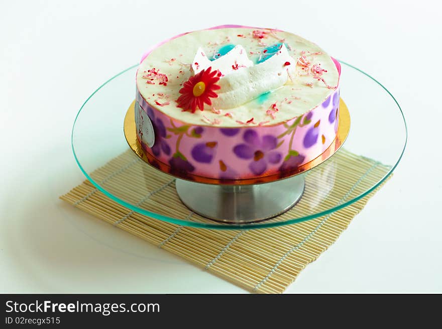 Cream cake on isolated background on glass plate. Cream cake on isolated background on glass plate