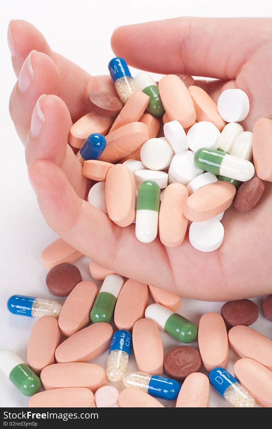 Medical pills in a female hand, isolated