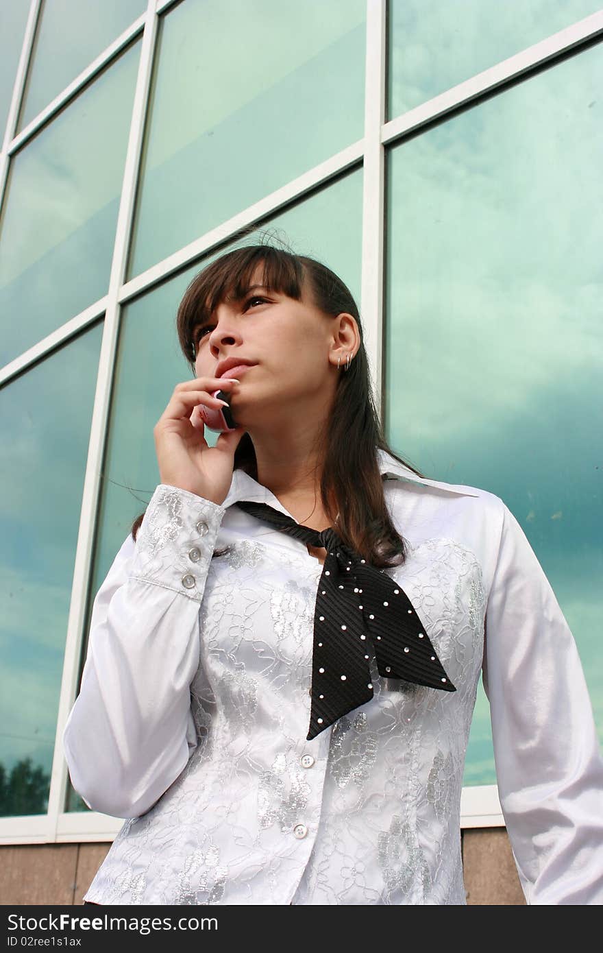 Businesswoman calling by phone outdoors