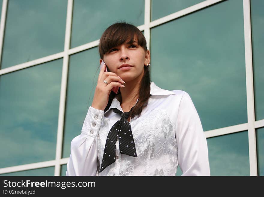 Businesswoman calling by phone outdoors