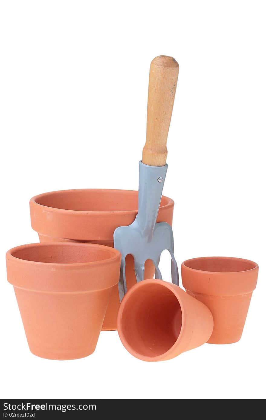 Steel rake on white background near to ceramic pots. Steel rake on white background near to ceramic pots.