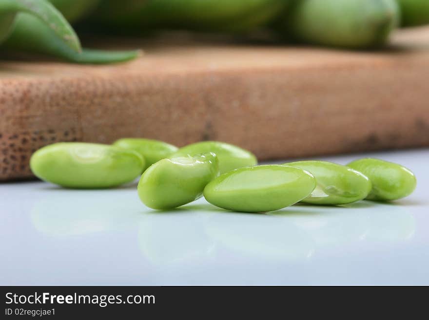 Vegetable kidney bean beans against on a kitchen board.