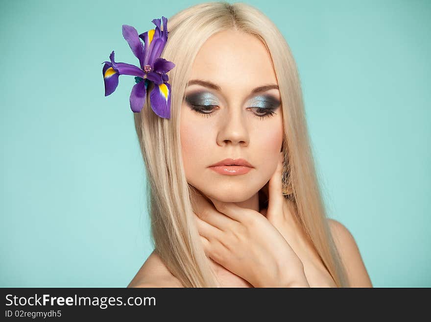 Beautiful blond in studio on the blue background. Beautiful blond in studio on the blue background