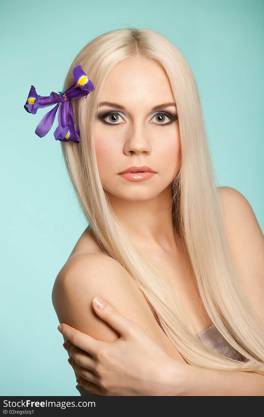 Beautiful blond in studio on the blue background. Beautiful blond in studio on the blue background