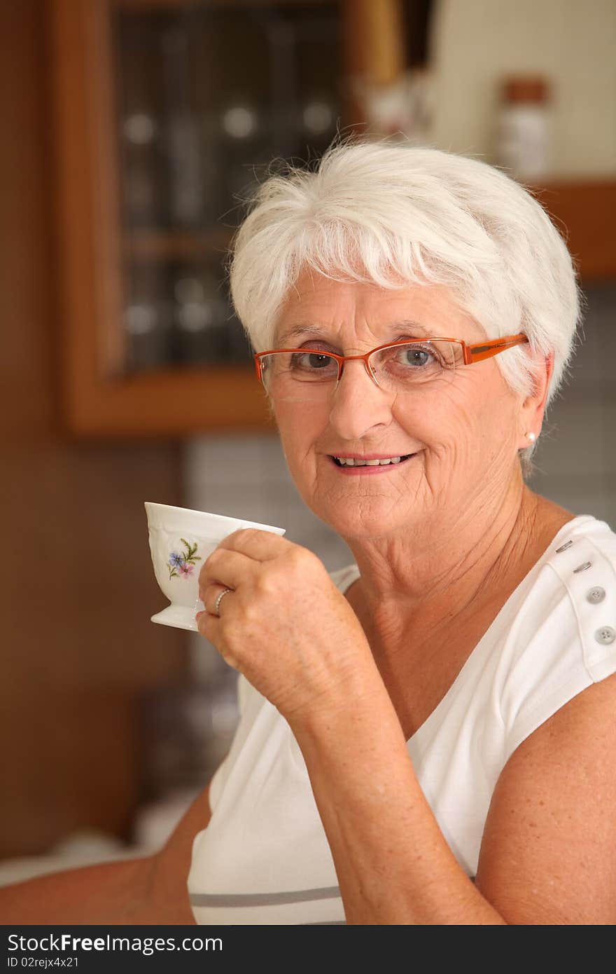 Closeup of senior woman with coffee cup