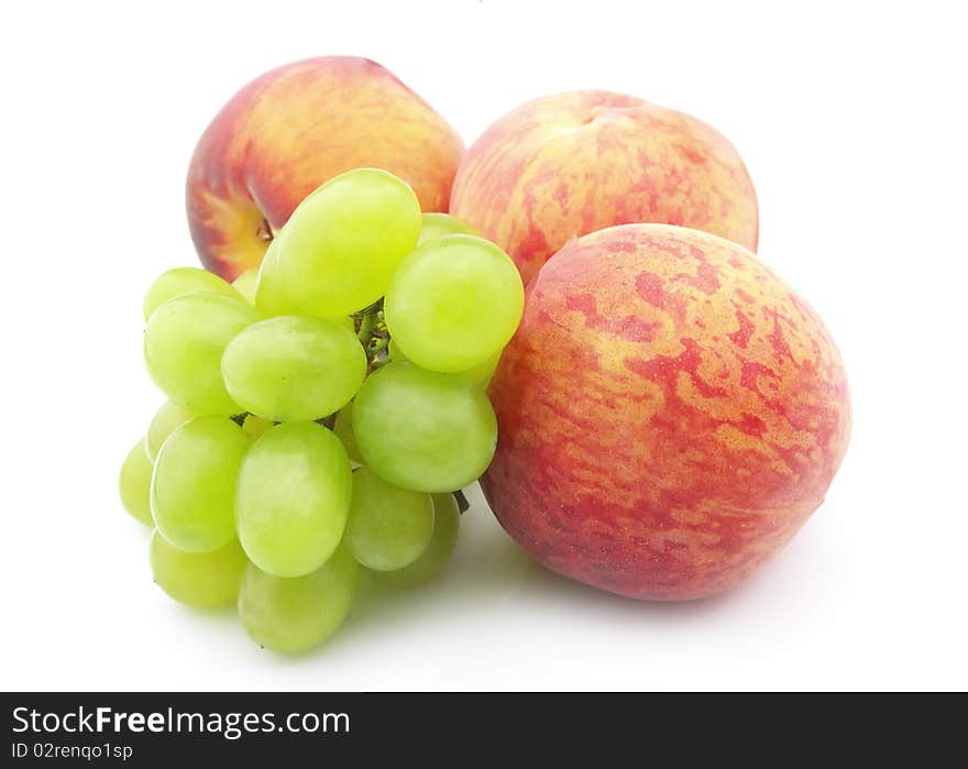 Ripe fruit, juicy grapes and fragrant peaches on a white background. Ripe fruit, juicy grapes and fragrant peaches on a white background