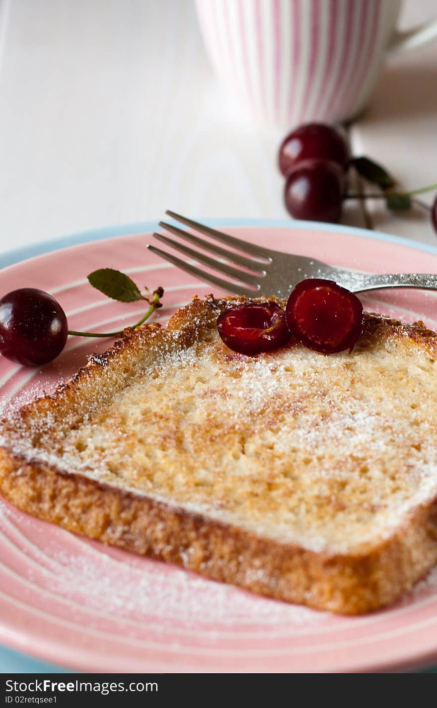 Toasted bread with cherries and powdered sugar