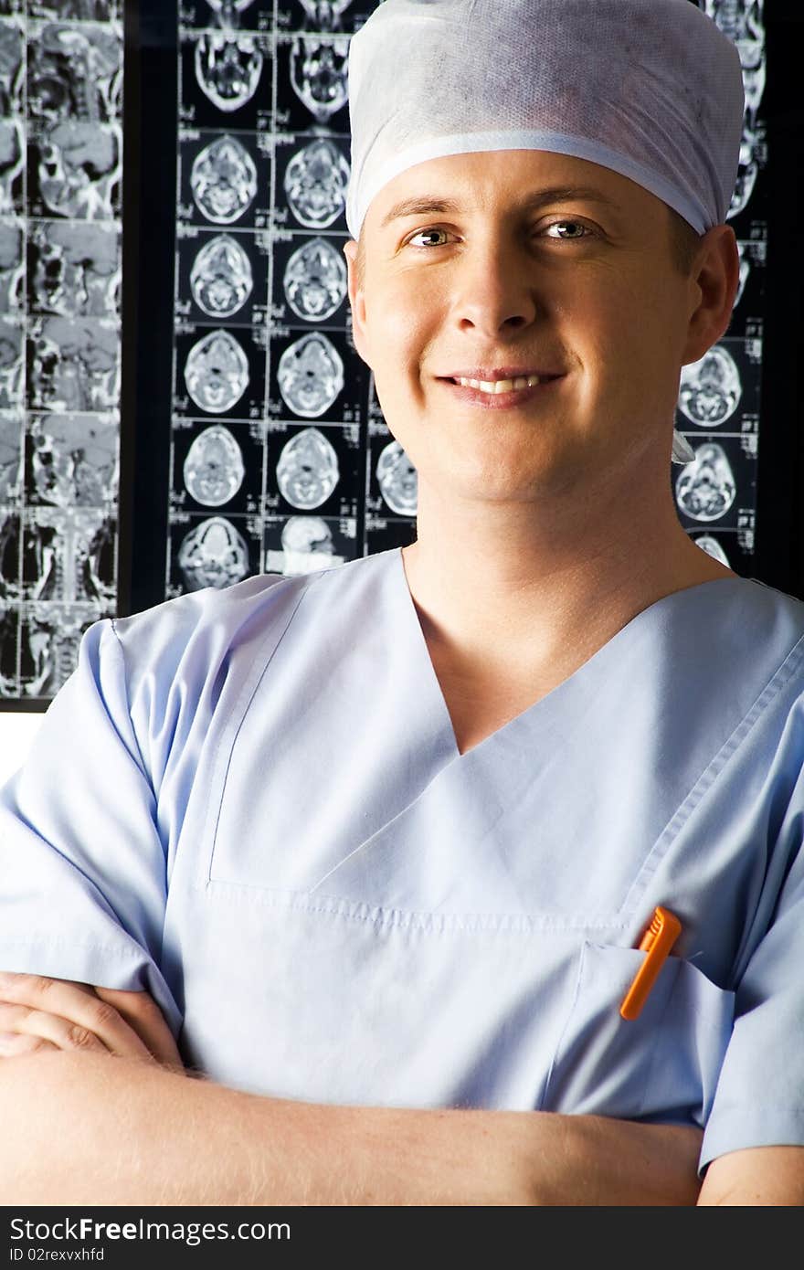 Photo of smiling surgeon in blue uniform. Photo of smiling surgeon in blue uniform