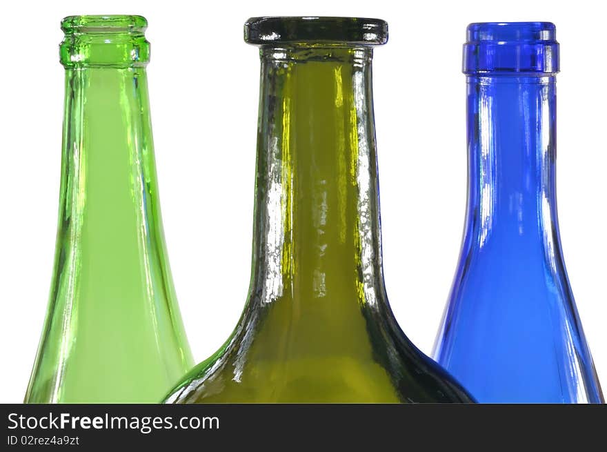 Three colored glass bottles against white background. Three colored glass bottles against white background