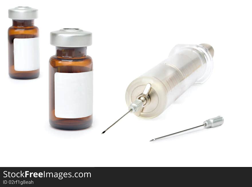 Old glass syringe and vaccine against white background