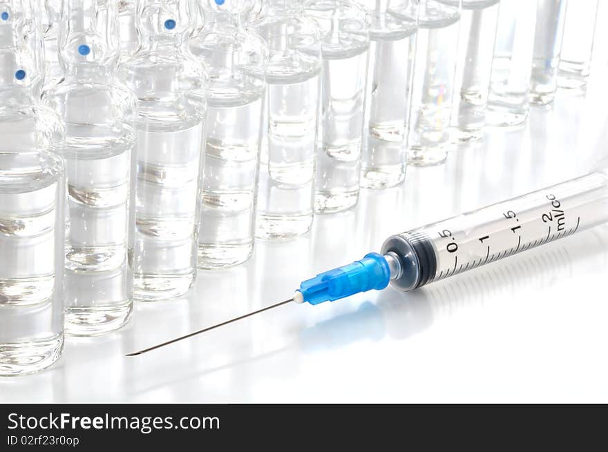 Single use syringe and vaccine against white background