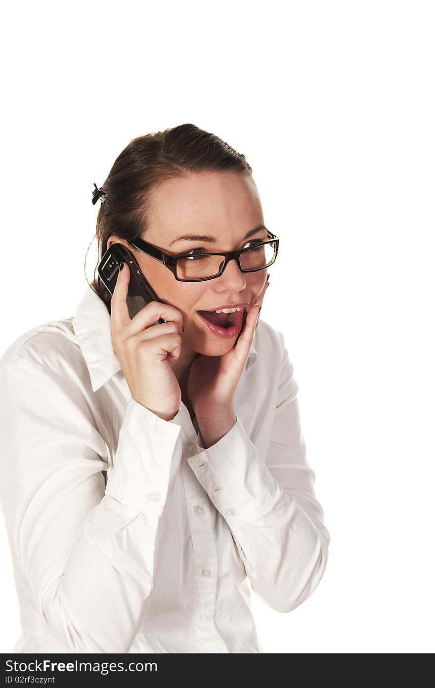 Beautiful girl getting good news on the phone, seen against white background