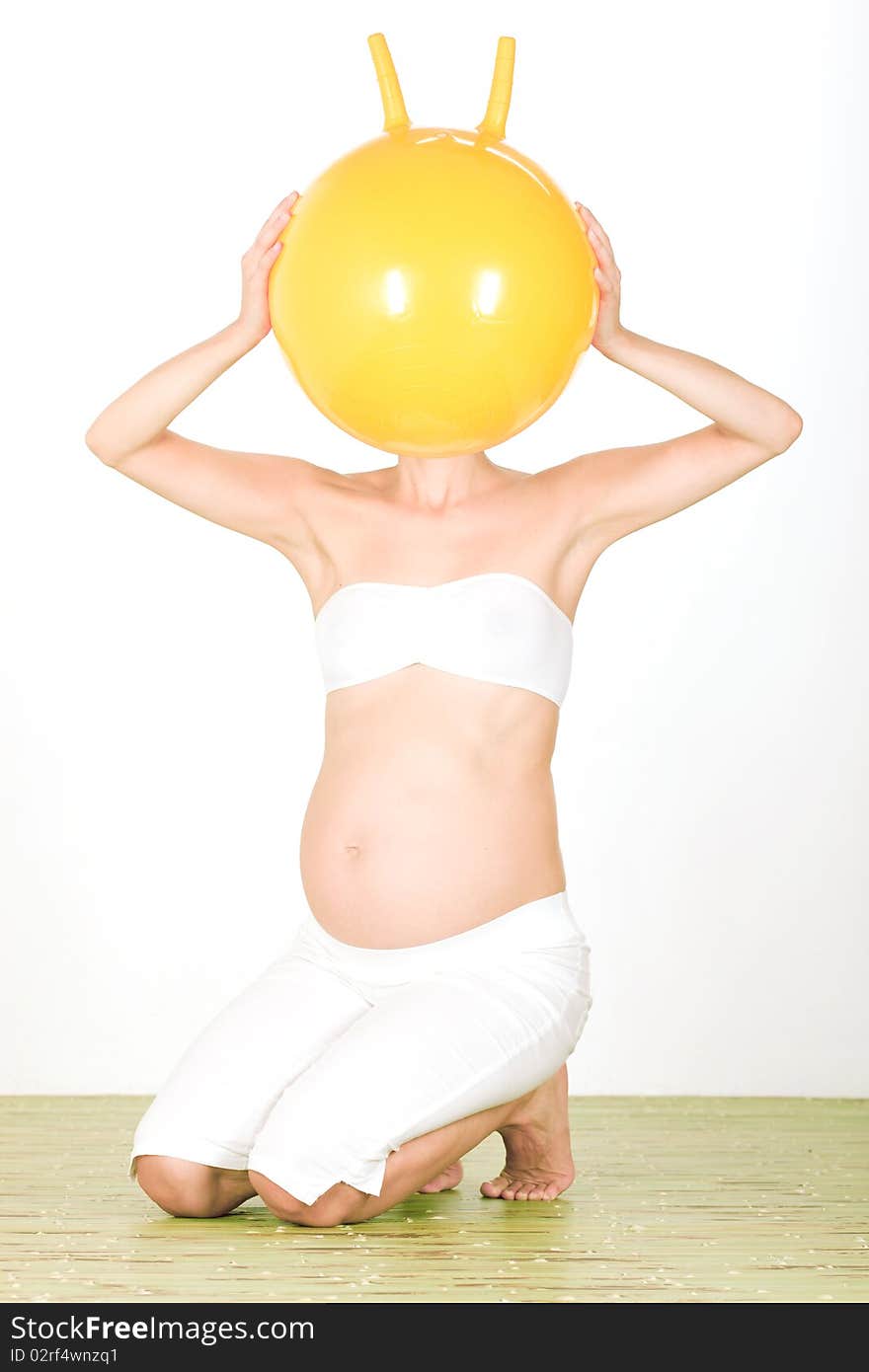 Portrait of pregnant woman with ball