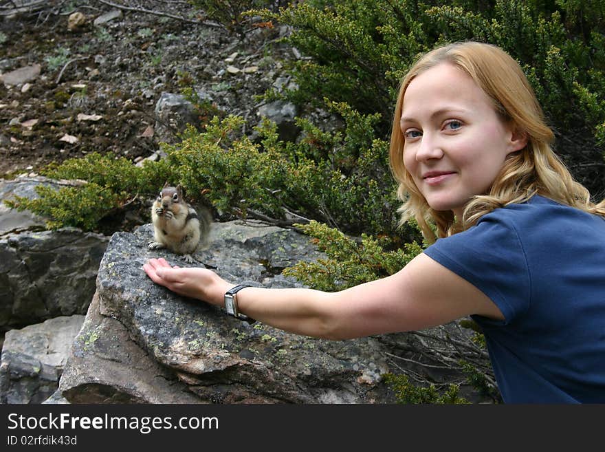 Lady feeding a chipmunk