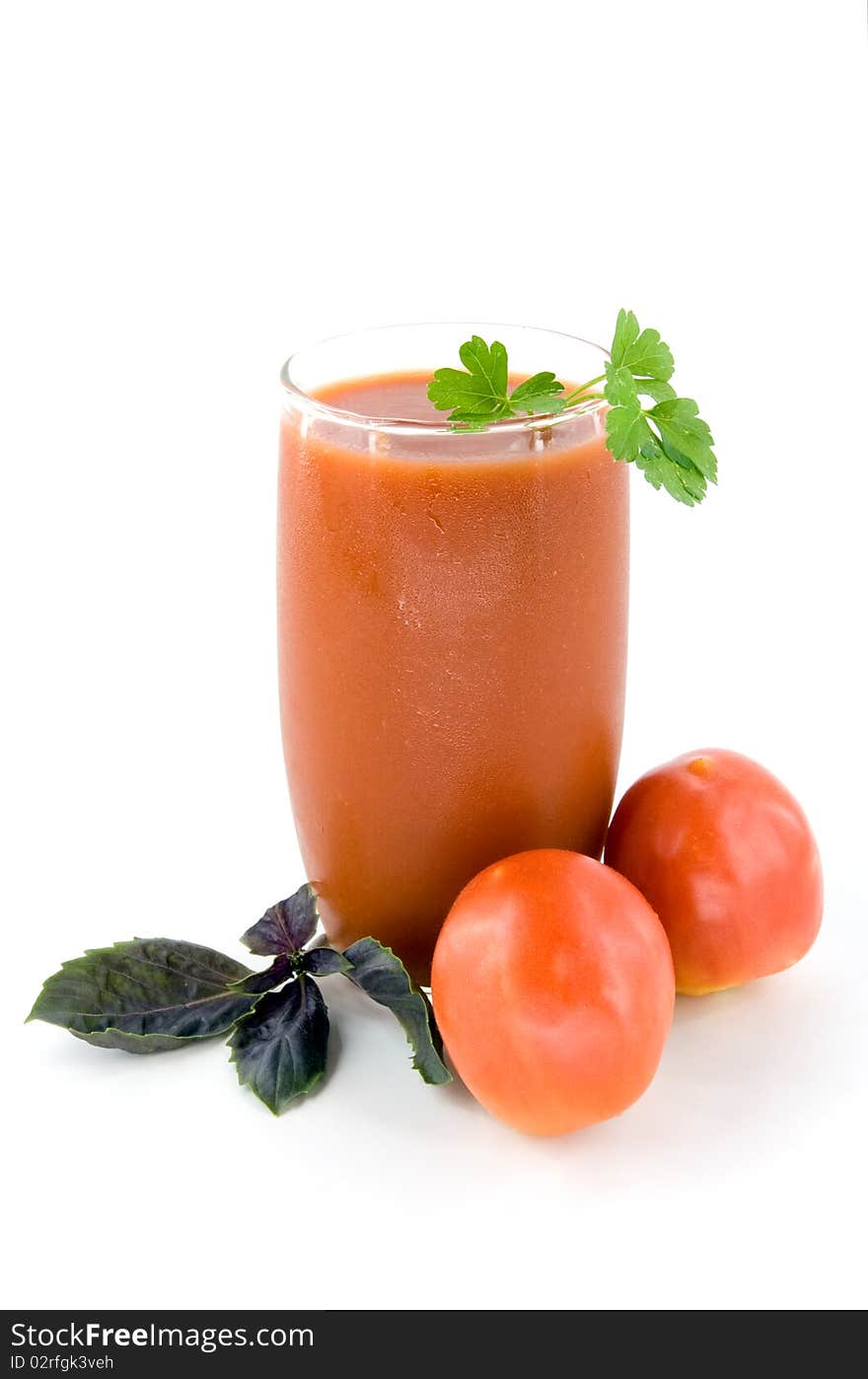 Small tomatoes and juice on white background