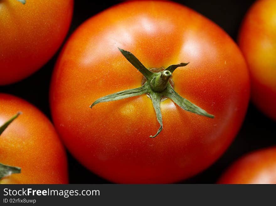 Bright red tomato with the stems close up